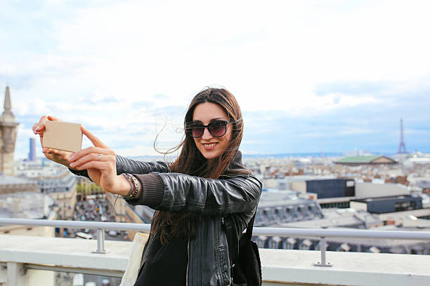 istock Young Parisian woman taking a selfie in Paris 539642588