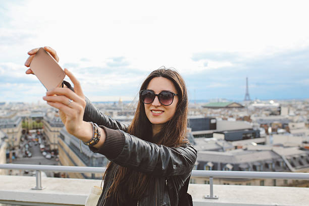 istock Young Parisian woman taking a selfie in Paris 539643704