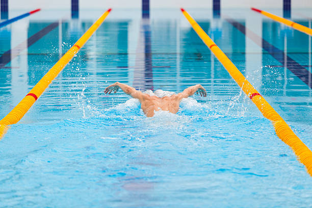 istock dynamic and fit swimmer in cap breathing performing the butterfly 539646526