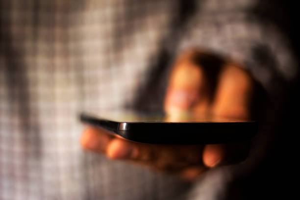 istock Close up of a man using mobile smart phone texting 539647288