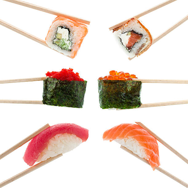 Japanese cuisine. Sushi nigiri roll and gunkan in chopsticks