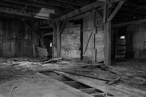 This image shows the interior of an old abandoned barn.