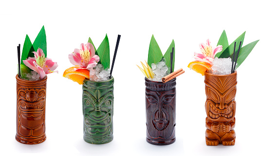 Tropical cocktails served in a tiki style glass and garnished with fruits