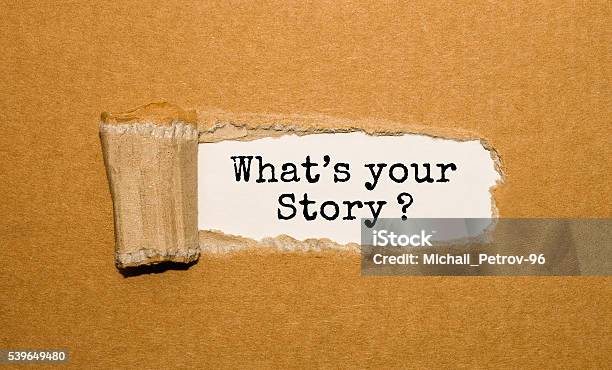 The Text Whats Your Story Appearing Behind Torn Brown Paper Stock Photo - Download Image Now