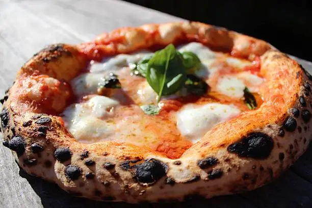 Neapolitan Pizza, baked at 500 degrees in a wood-fired oven. Made with organic 00 flour from Marino Marino in Piemont, Italy
