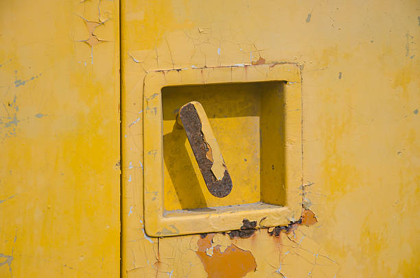 istock An old yellow metal door with rust and shadow. 539652522