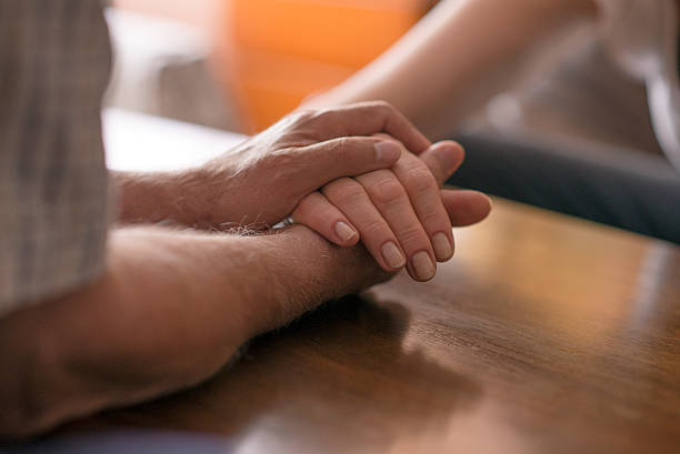 istock Cropped image of senior couple holding hands while sitting 539653102