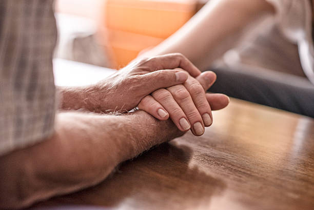 istock Old couple holding each others hands 539653178