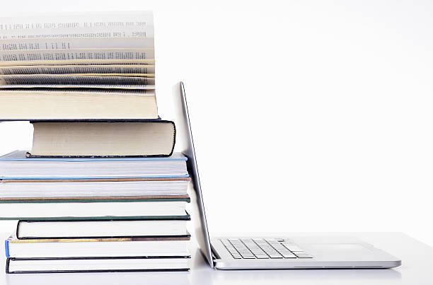 istock Open laptop screen leaning against a stack of books 539653210
