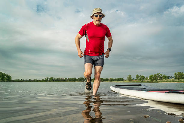 istock senior paddler with  stand up paddleboard 539654988