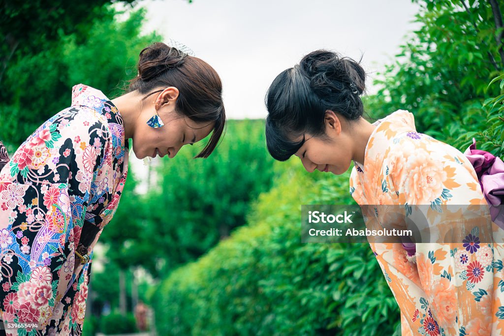 Beautiful Japanese Women in Kimono Bowing, Kyoto, Japan Portrait of beautiful japanese women in kimono bowing to each other in Gion, Kyoto, Japan. Waist up, side view. Copy space. Nikon D800, full frame, XXXL. iStockaLypse Kyoto 2016. Japan Stock Photo