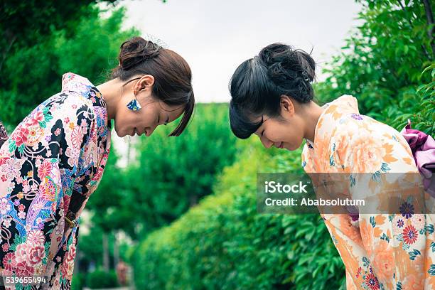Beautiful Japanese Women In Kimono Bowing Kyoto Japan Stock Photo - Download Image Now