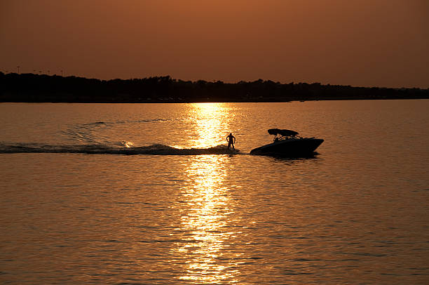 Recreational boat on a lake at sunset stock photo