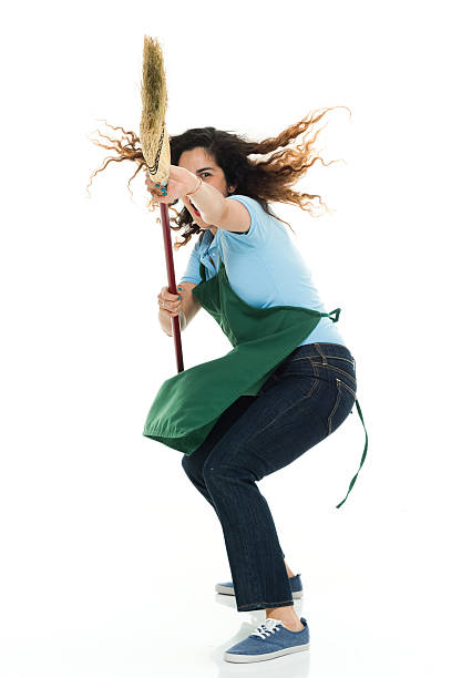 istock Female janitor fighting with broom 539662176