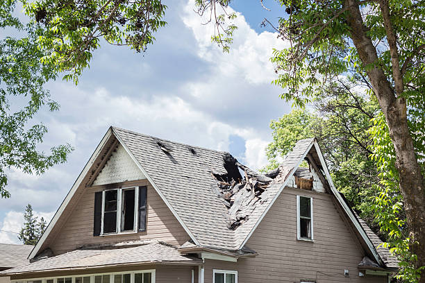 roof of a house burned and caved in. horizontal close up image of a roof of a house that has burned and fallen in under blue sky with cloud in summer time. breaking stock pictures, royalty-free photos & images