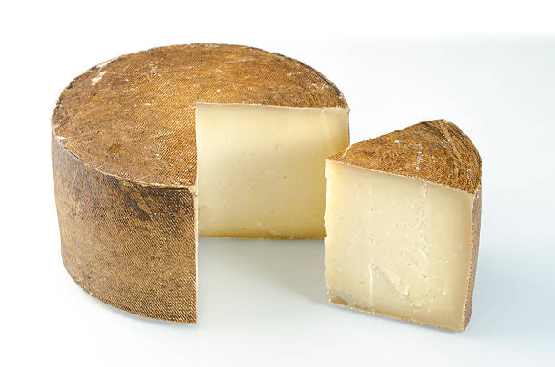 istock Whole wheel of sheep milk cheese over white background. 539663792