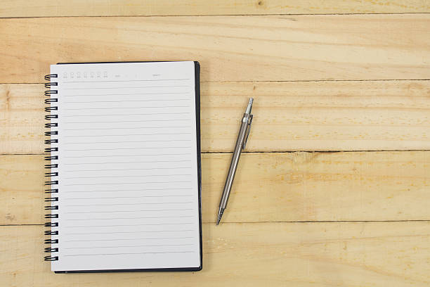 istock Blank note paper with pen on wood background 539665554