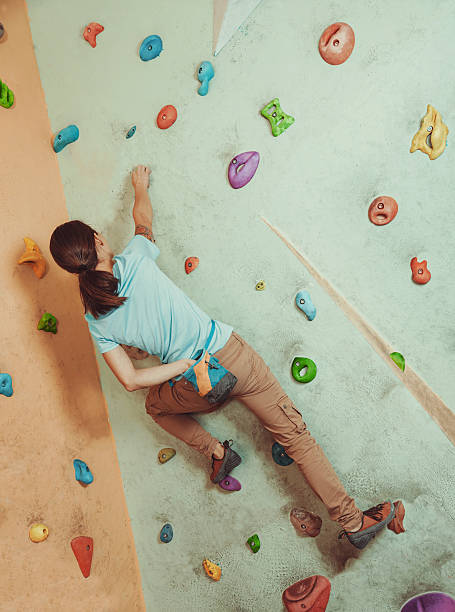 istock Climber girl coating her hand in powder magnesium 539667040