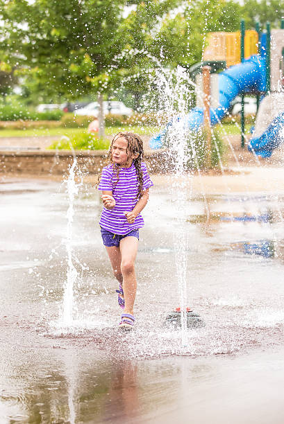 istock Girl Running Through Fountain at Splash Park 539667142