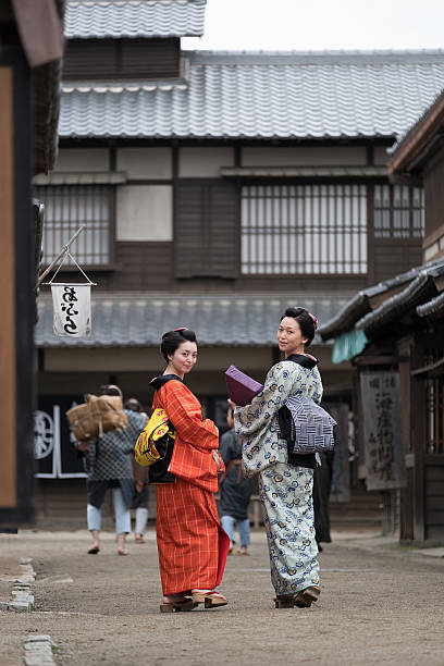 istock Two Traditionally Dressed Japanese Women in Kimonos, Walking, Looking Back 539669418