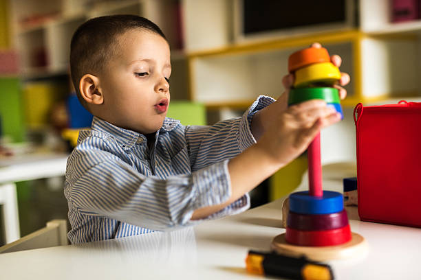 istock Little boy at preschool playing with educational stacking toy. 539673796