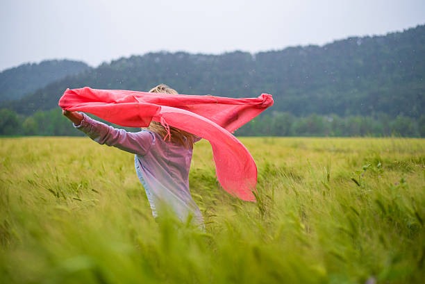 A beautiful young girl dressed in red poses in 