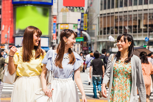 Three japanese woman friends meeting together for shopping in Tokyo Shibuya, Japan.