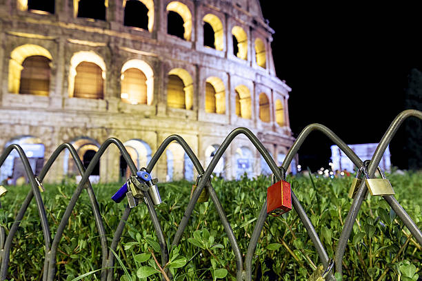 Red padlock in front of the Colosseum in Rome stock photo