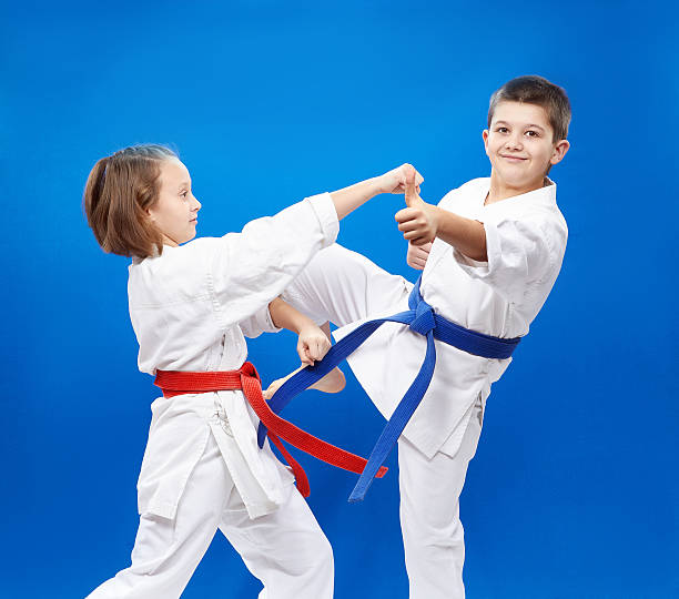 istock Cheerful athletes train blows and blocks karate 539678730