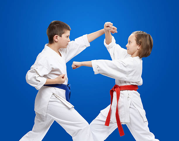 istock With red and blue belt athletes train kicks and blocks 539680096