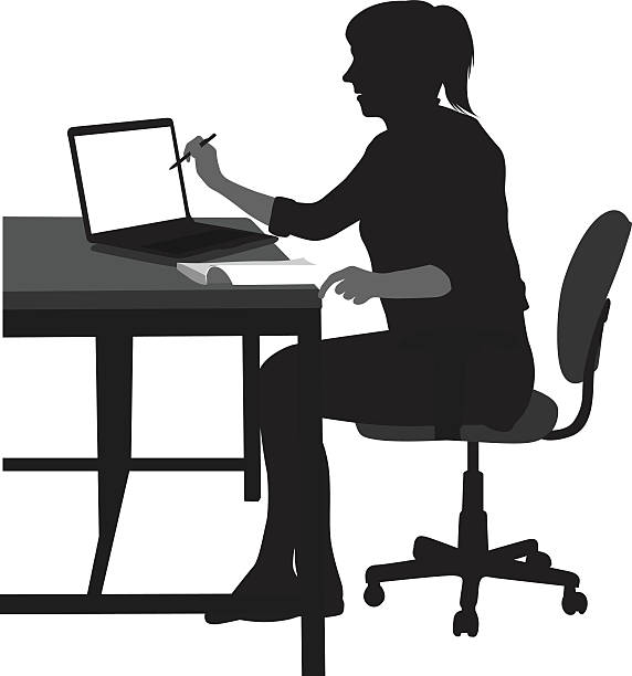 Young Arts Student A vector silhouette illustration of a young woman sitting at a desk with a book and laptop open.  She points at the laptop screen with a pen and sits with legs crossed. working at home study desk silhouette stock illustrations