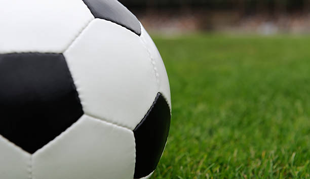 istock Soccer ball on green grass 539680228