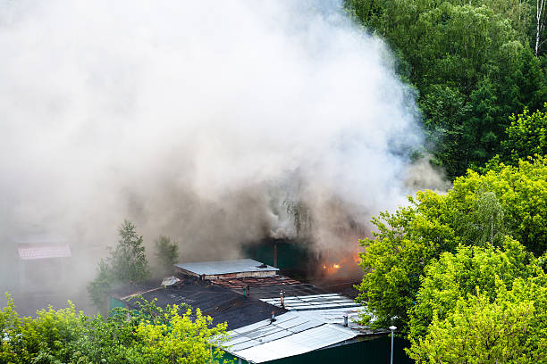 istock wet roofs, burning garage and white smoke 539681108