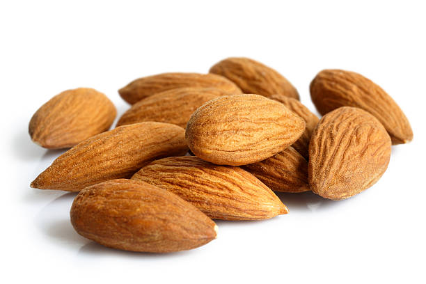 istock Pile of whole almonds isolated on white. 539685786