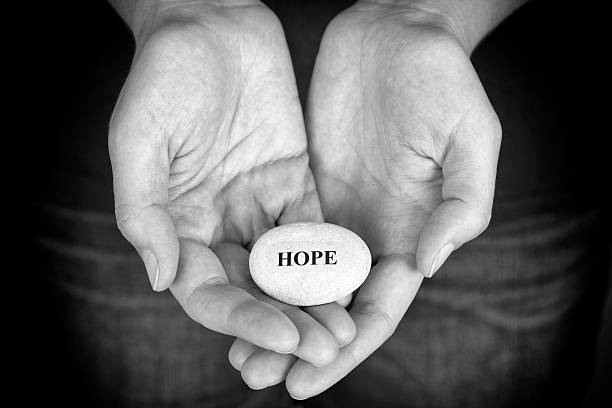 istock Stone with the word Hope in the woman's palms 539686360