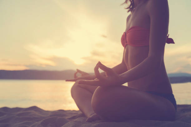 istock Young woman practicing yoga on the beach. 539686476
