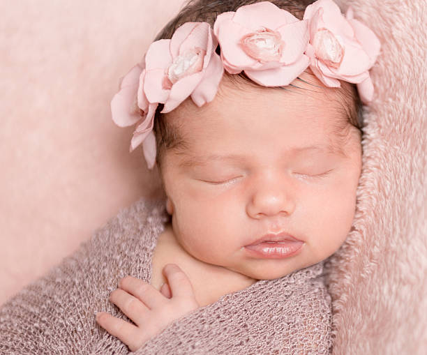 istock infant girl sleeping on a pink background 539686670