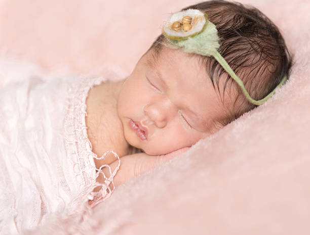 istock infant girl sleeping on a pink background 539686866