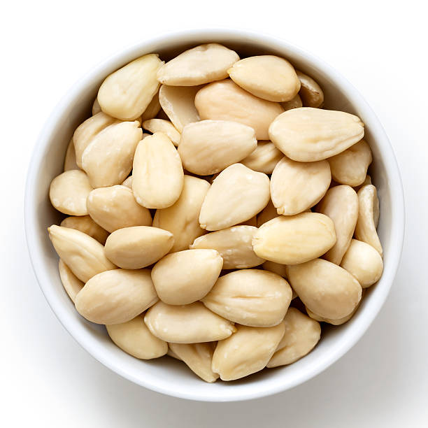 istock Bowl of peeled whole almonds isolated on white from above. 539687348