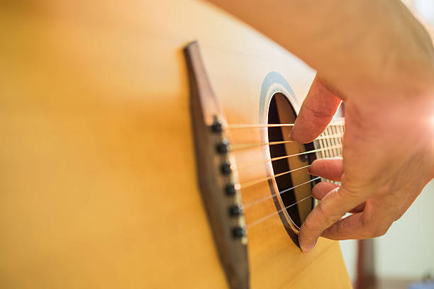 istock Man's hands playing acoustic guitar. 539808866