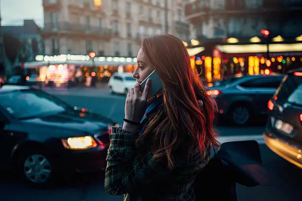 Photo of Woman talking on the phone at night