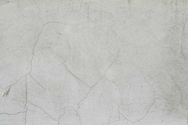 istock Gray plaster weathered wall with stains and cracks 539809550