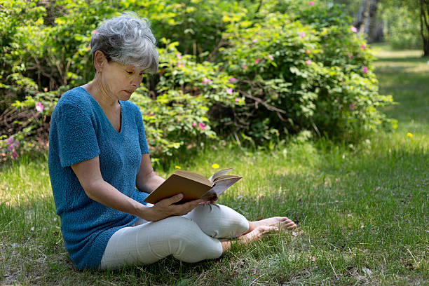 istock Senior woman reading a book 539809590