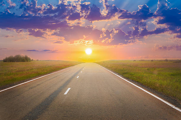 istock sunset over the country highway 539809914