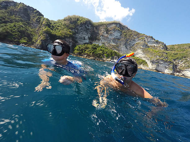istock shoot of a young boy snorkeling with father 539810118