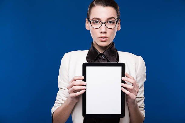 istock brunette in glasses with a tablet in hands 539812582