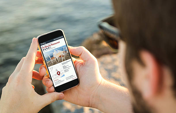 Man using his mobile phone  to search on online dire