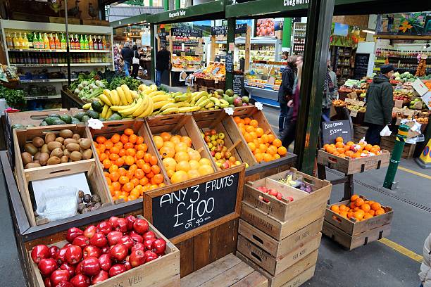 London, UK - April 22, 2016: People shop at Borough Market in Southwark, London. It is one of oldest markets in Europe. Its 1,000th birthday was in 2014.