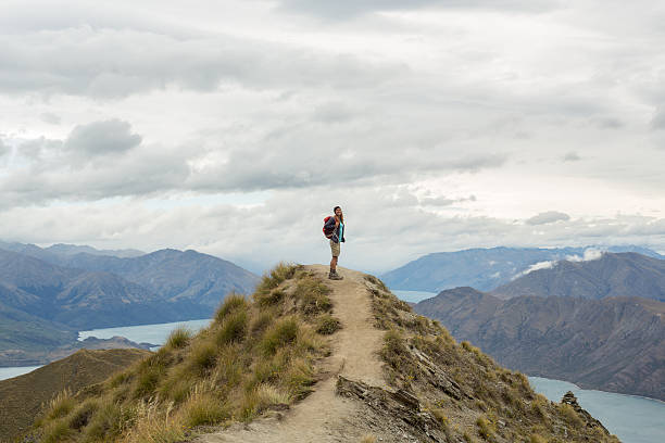 istock Hiker reaches mountain top 539814834