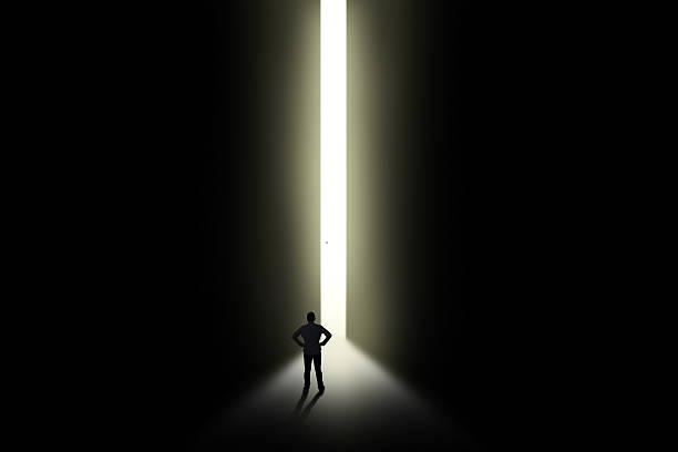 istock Man with bright light in doorway 539814874